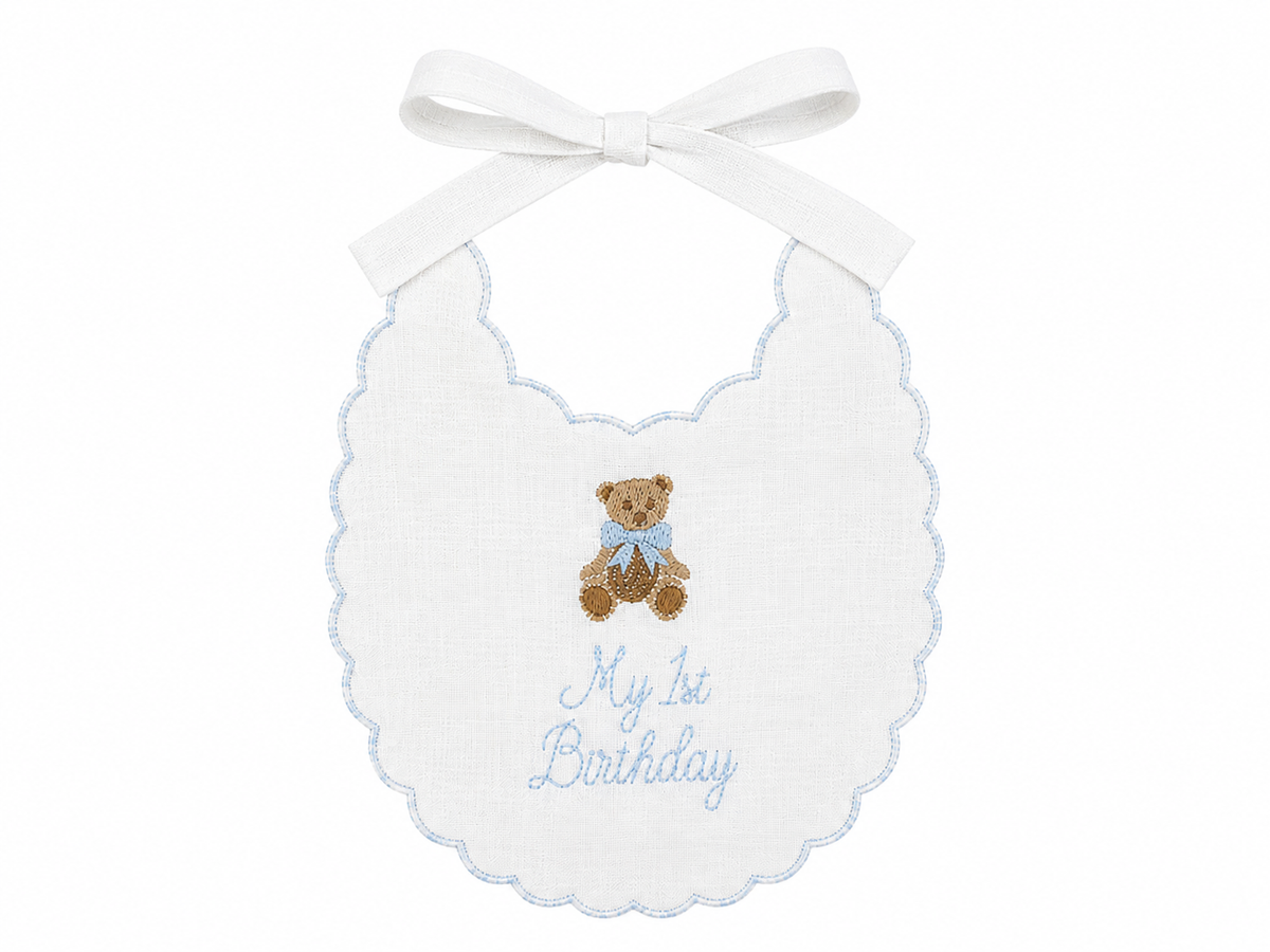 Blue Teddy Bear linen first birthday bib with embroidered teddy bear and blue details