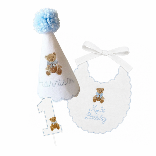 Blue Teddy Bear 3-piece first birthday cake smash set with personalized party hat, birthday bib, and teddy bear cake topper