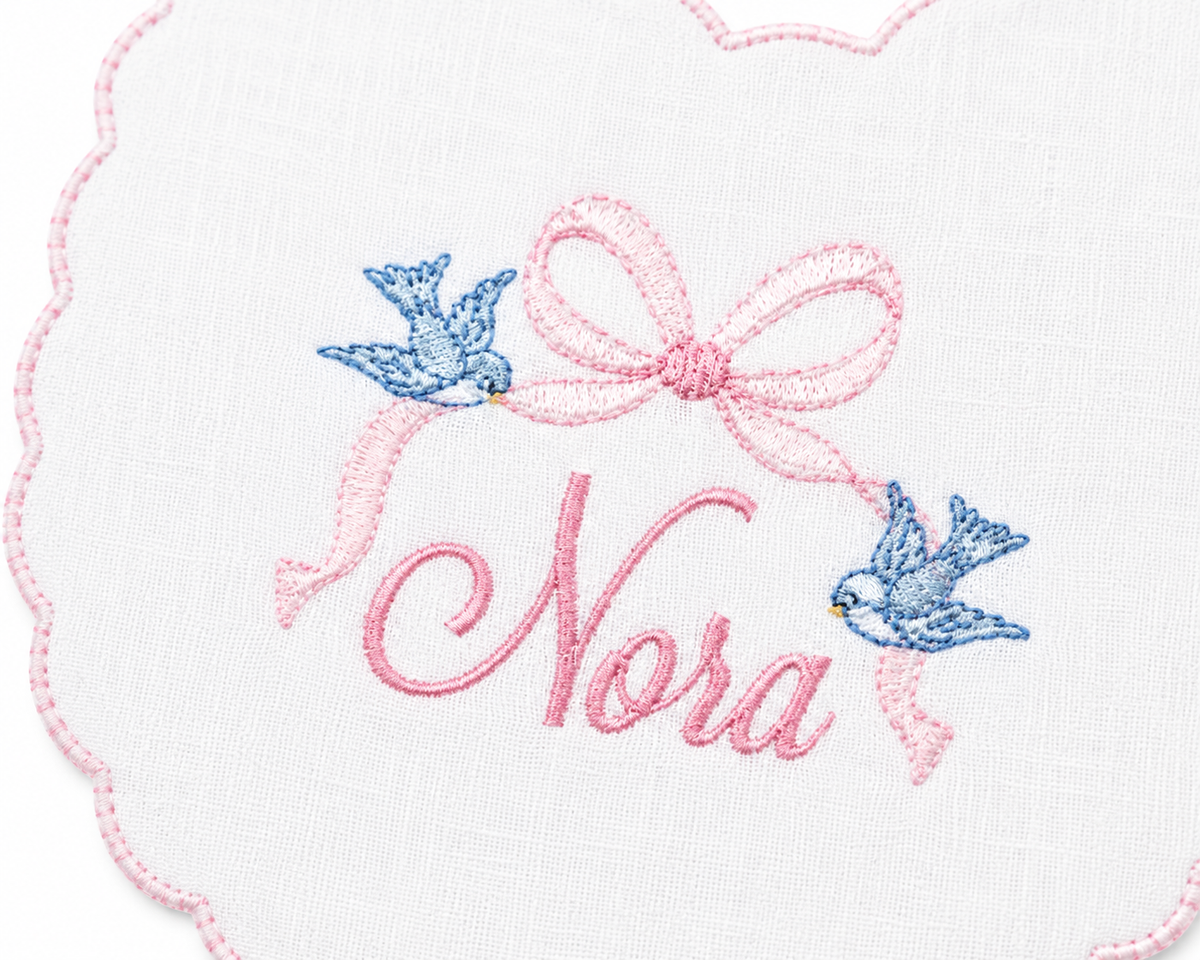 Cinderella Bow personalized linen first birthday bib with embroidered name, detail view