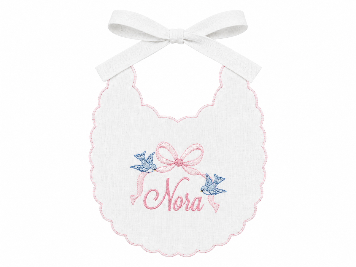 Cinderella Bow personalized linen first birthday bib with embroidered name and storybook bow details