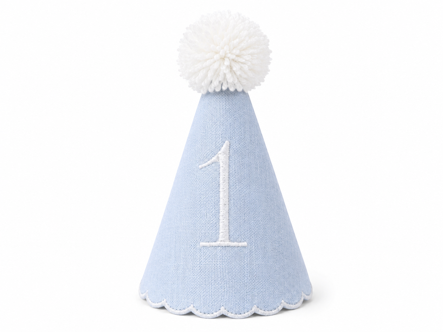 Classic blue linen first birthday party hat with white embroidered number 1, white scalloped trim, and white pom pom