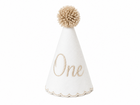 Classic Khaki linen first birthday party hat with khaki embroidered ONE, scalloped edging, and pom topper