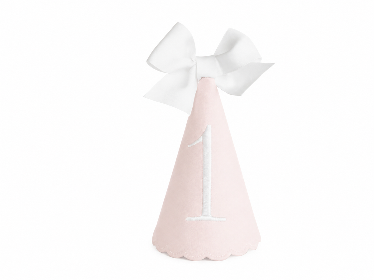 Classic Pink linen first birthday party hat with white embroidered ONE and bow topper