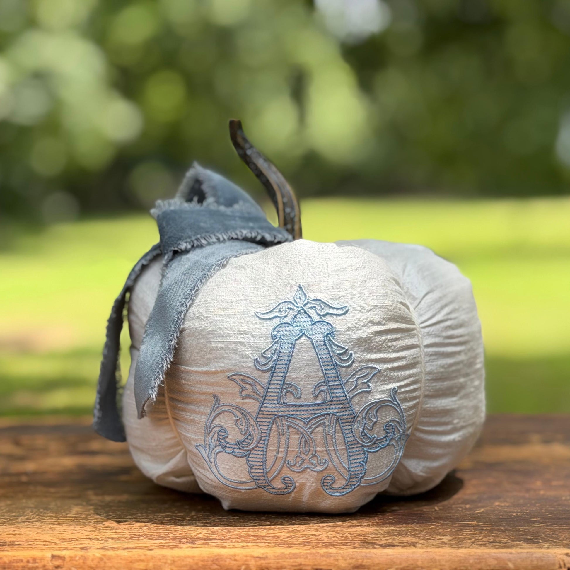 Ivory silk Chateau pumpkin with blue velvet bow and layered embroidered initial