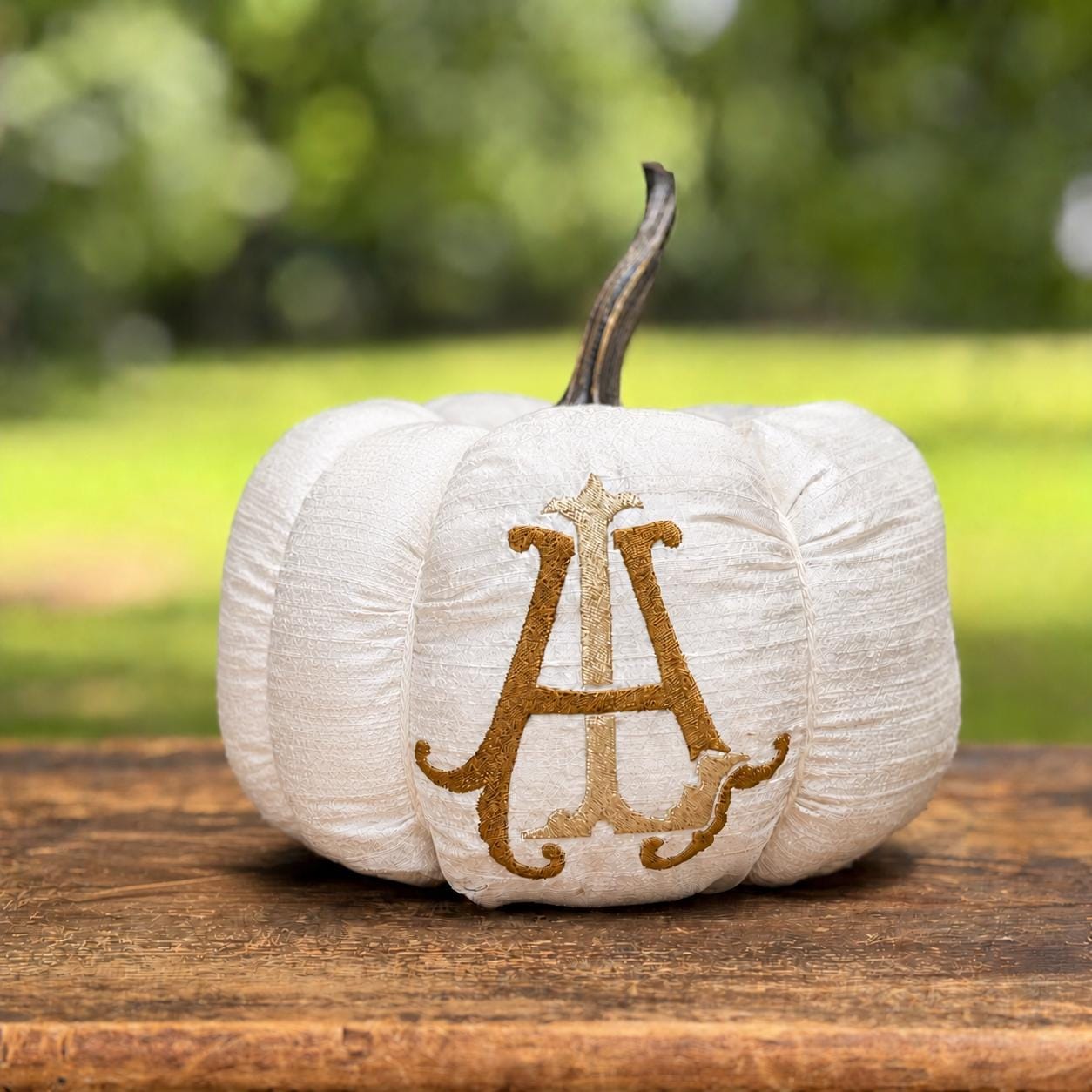 Ivory silk dupioni pumpkin with layered gold initial monogram and resin stem