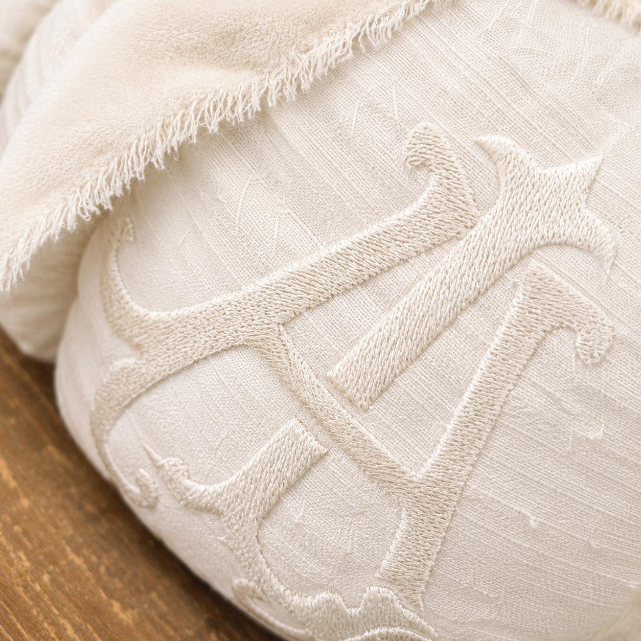 Close-up of layered monogram embroidery on the Monroe ivory silk pumpkin