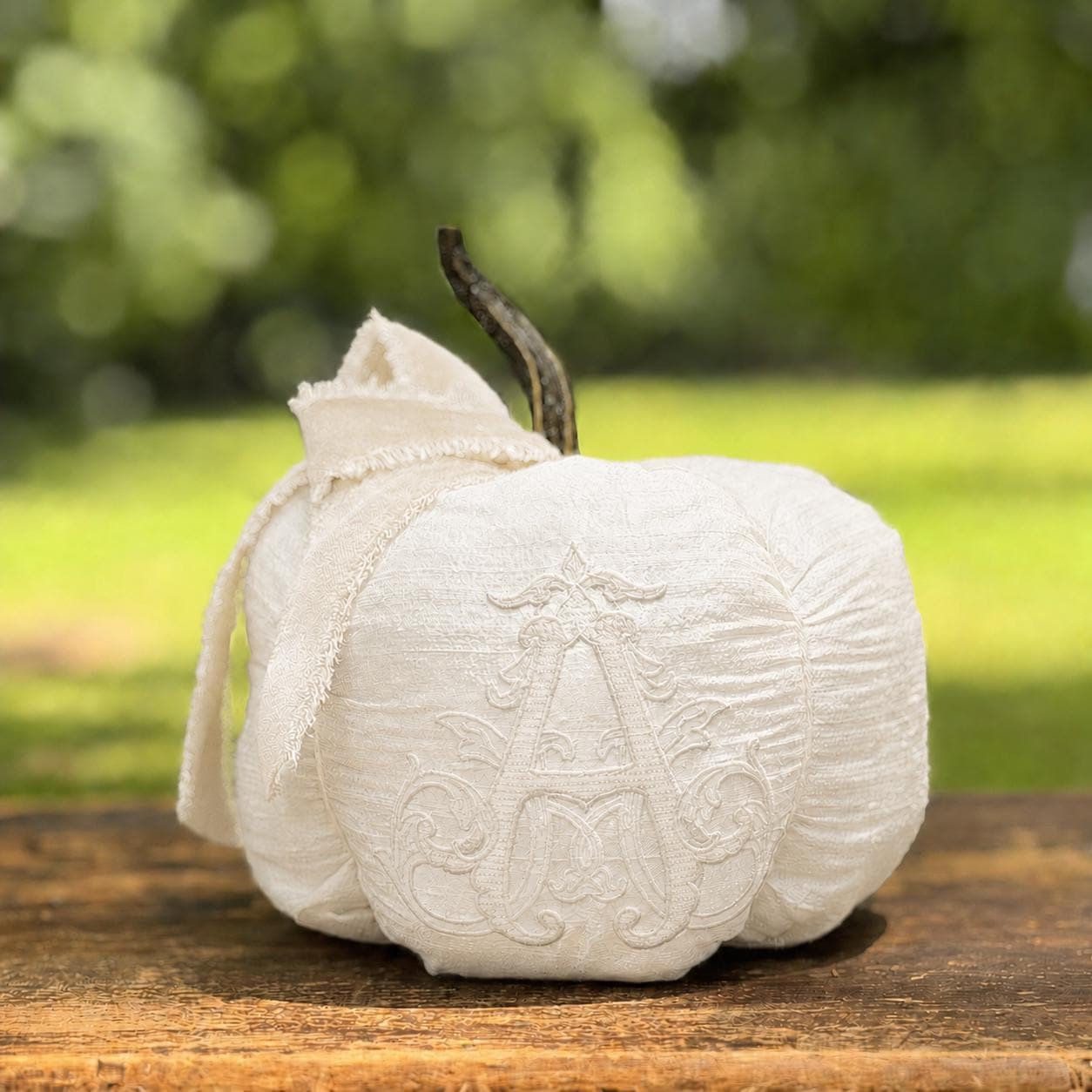 Tone-on-tone ivory Chateau silk pumpkin with velvet bow and monogram