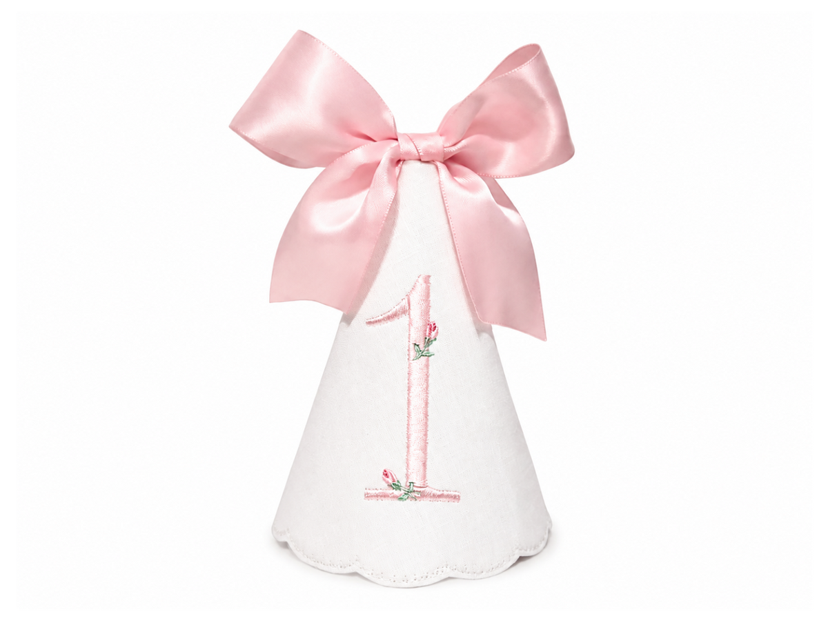 Rosette linen first birthday party hat with pink rosette embroidery and bow topper