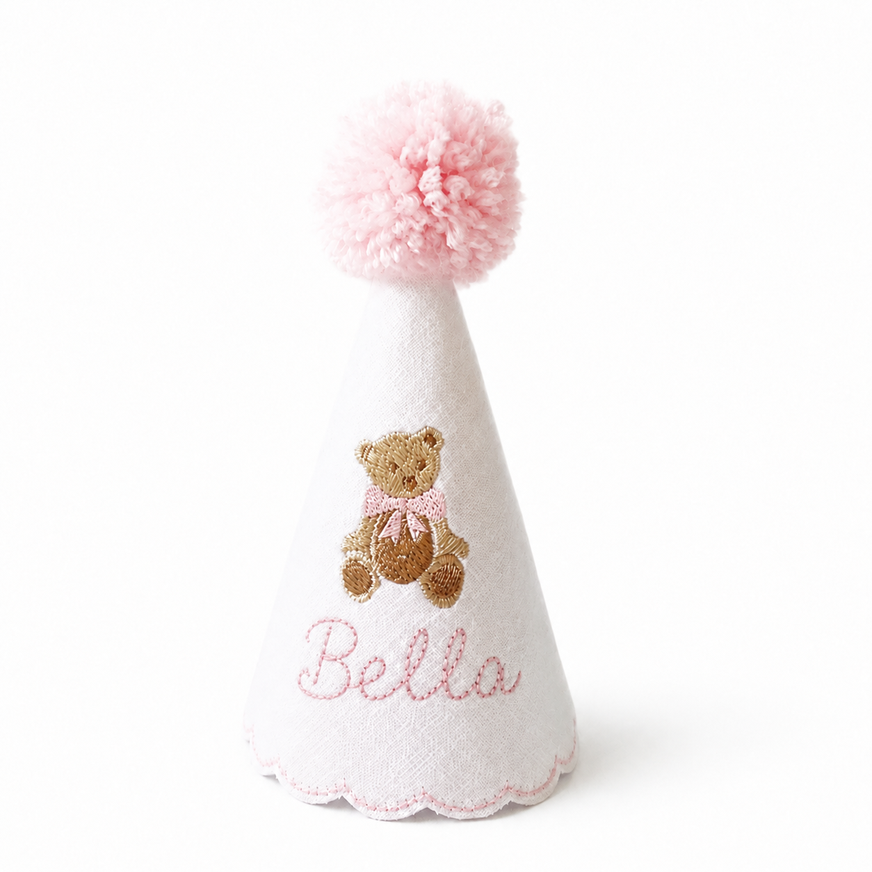 Personalized pink teddy bear birthday party hat with light pink pom pom, pink scalloped trim, and the name Bella